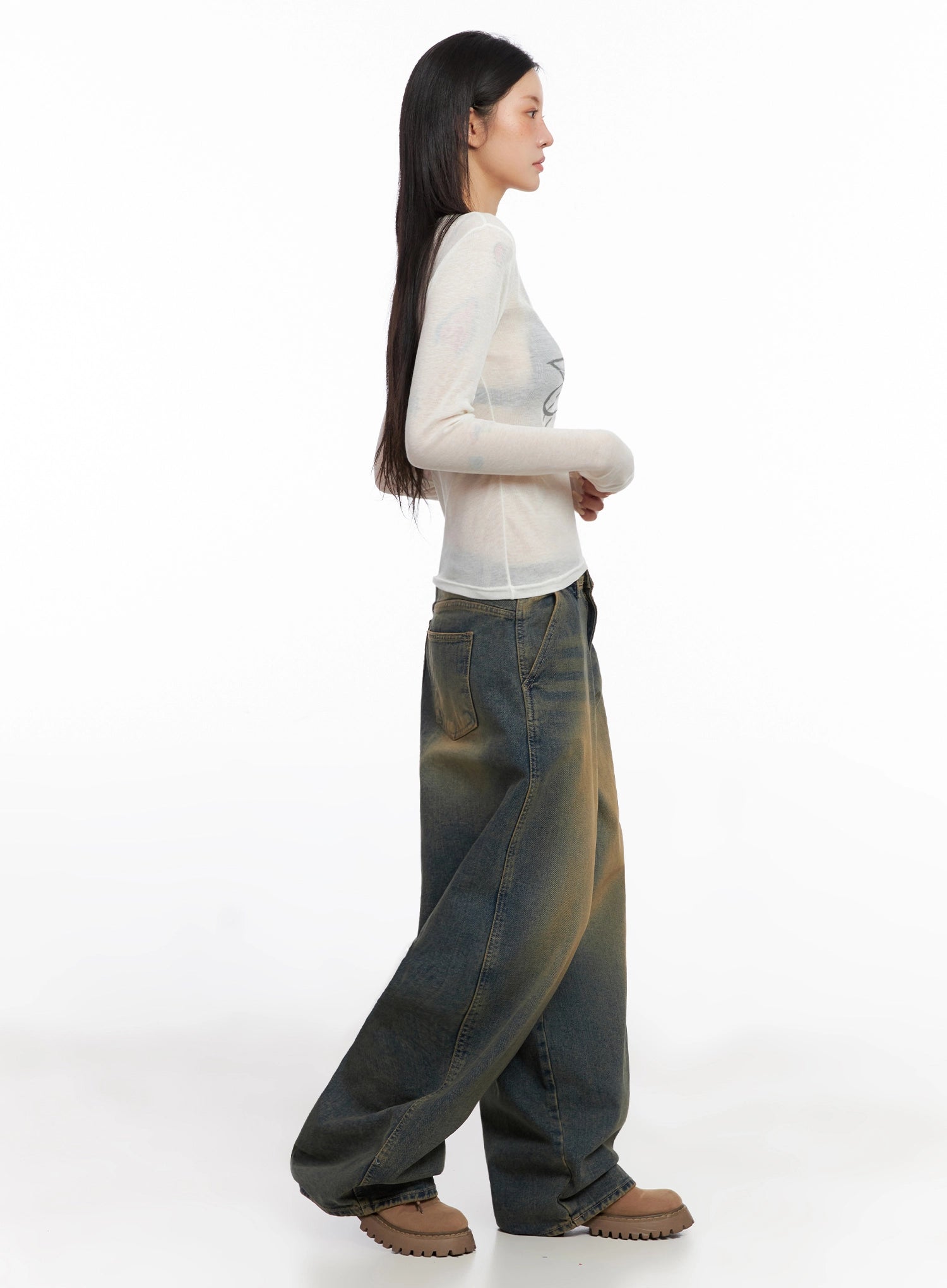 Minju Vintage Washed Baggy Jeans IS508 in dark blue, side full-length on model in profile, paired with sheer white long sleeve top, showing maxi wide leg volume and vintage wash gradient.