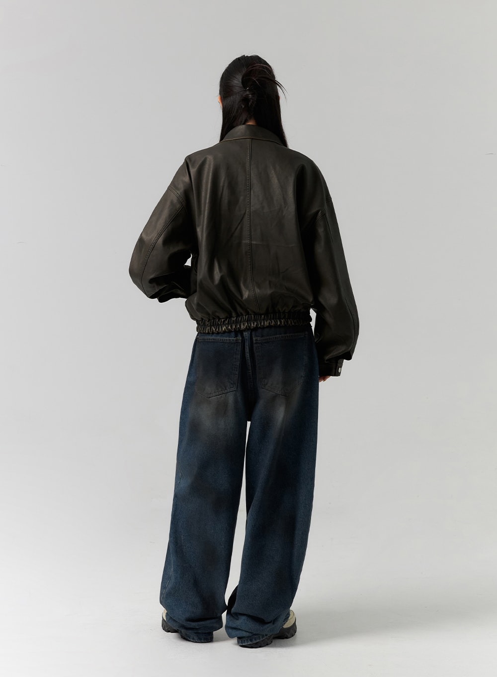 Tie-Dye Washed Wide Leg Jeans CS320 in dark blue, full-body back view on model, displaying patch pockets, tie-dye washed wide leg cotton denim paired with leather bomber jacket.