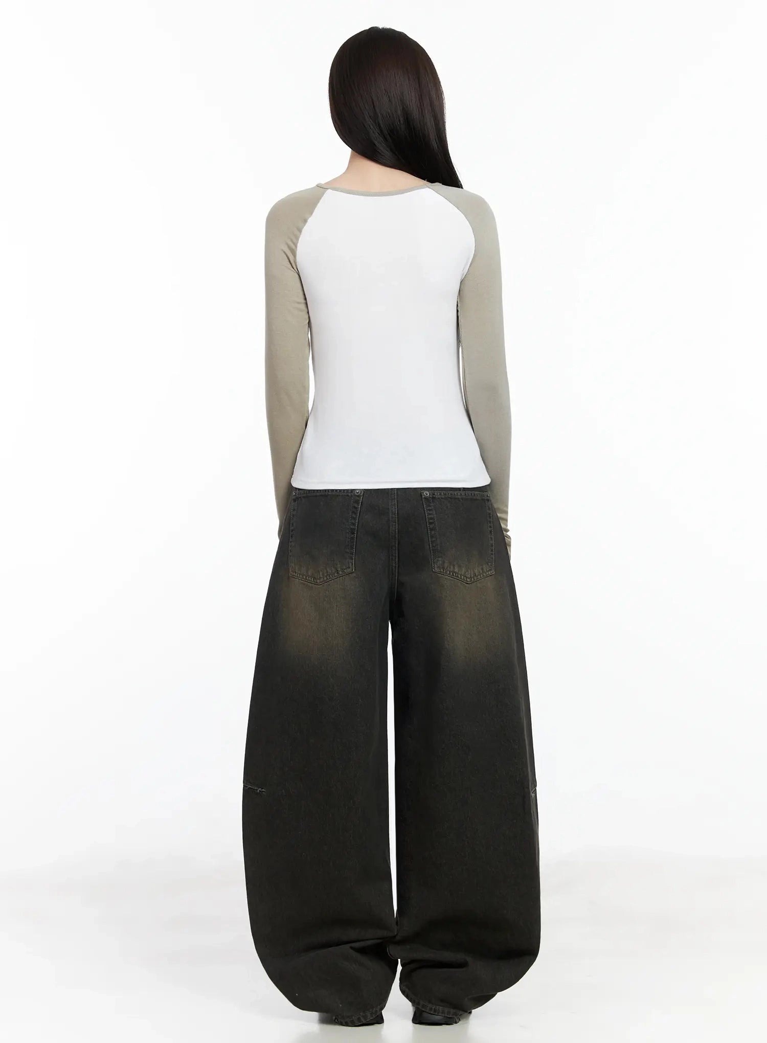 Tracey Vintage Black Washed Wide Leg Jeans IJ528 in black, full back view on model, large back patch pockets, black-to-brown vintage wash gradient, balloon wide leg pooling at floor, chunky boots.