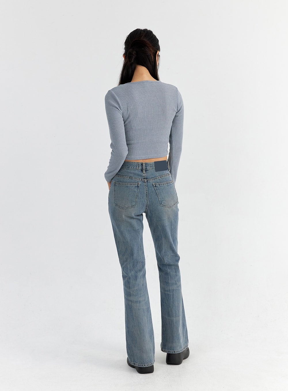 Vintage Washed Bootcut Jeans CO325 in blue, full-body back shot on model, back patch label and twin pockets visible, slim fit washed denim with bootcut silhouette from behind.