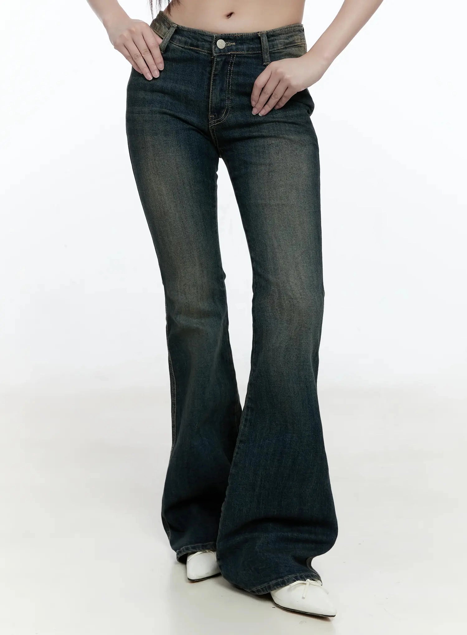 Karla Vintage Logo Hip Pad Flare Jeans IO520 in washed dark blue, front lower-half on model, close view of low-rise waist, front pockets, and dramatic flare leg in cotton-spandex denim.