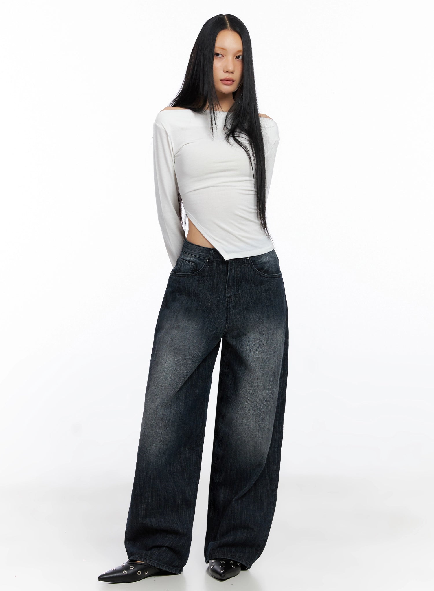 Minnell Vintage-Wash Wide-Leg Jeans IO517 in dark blue, full-body front view on model, paired with white off-shoulder long-sleeve top and black studded heels, casual street styling.
