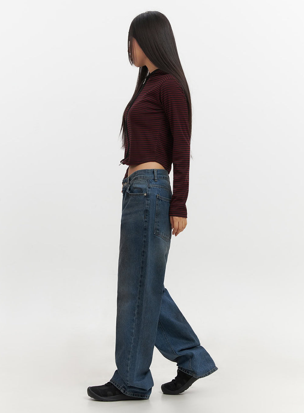 Brianna Dark Washed Wide-Leg Jeans IF510 in dark washed blue, side full-body on model walking, wide-leg baggy silhouette in motion, dark fade wash denim, paired with red striped crop top.