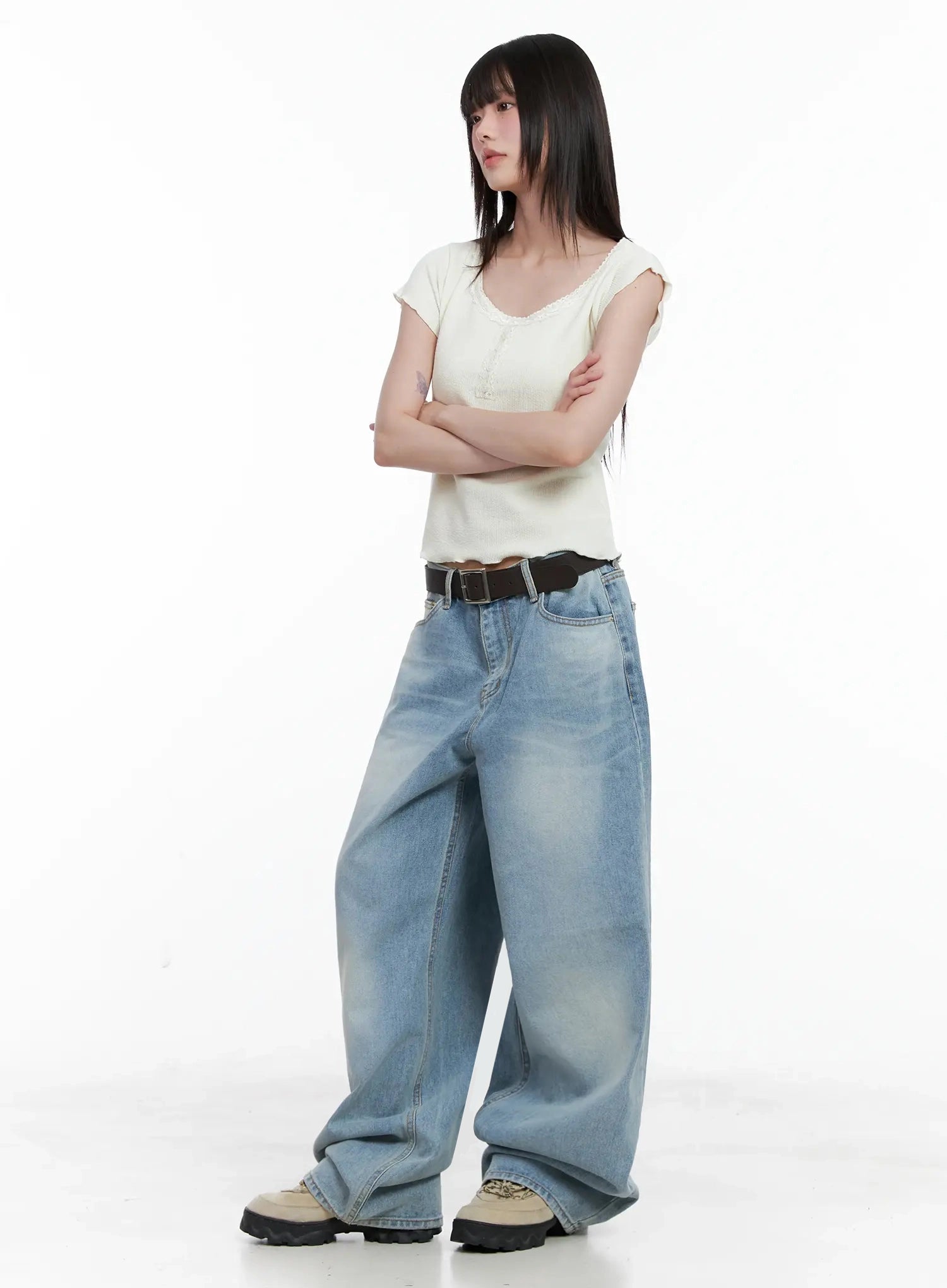 Dain Washed Wide-Leg Jeans IL531 in light blue, full-length front shot on model with arms crossed, styled with ivory lace-trim crop tee and dark belt, casual streetwear look.