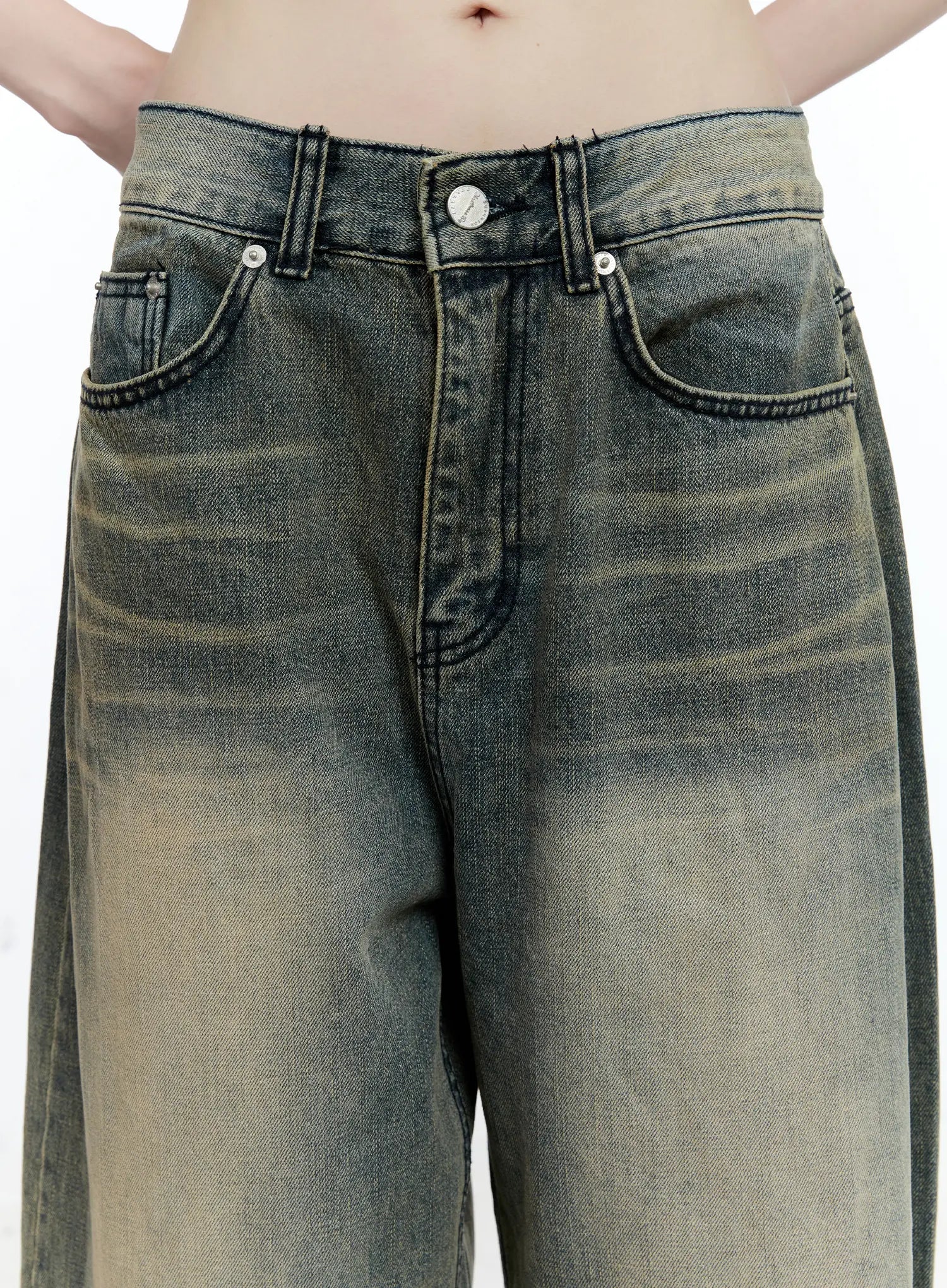 Yeonsoo Vintage-Wash Wide-Leg Jeans CG507 in vintage blue, close-up of waistband and front pockets on model, silver button, contrast dark stitching, yellow-tinted vintage wash fading.