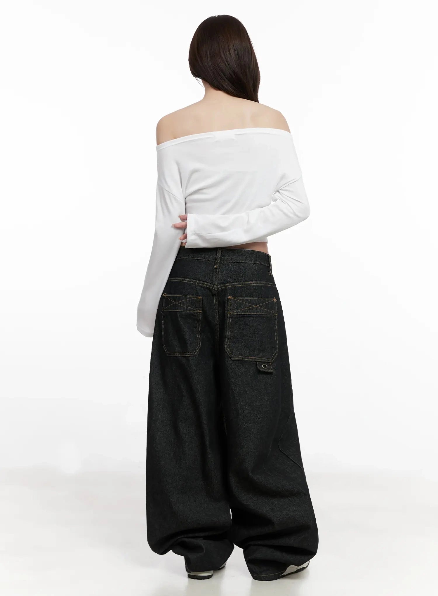 Halo Wide Leg Stitch Detail Jeans IN514 in black, back full-body shot on model, oversized patch pockets with X stitch and rivet detail, balloon hem pooling at heel, with white off-shoulder top.