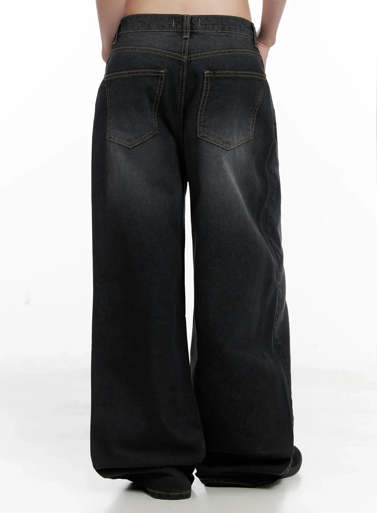 IU Vintage Black Baggy Jeans IL528 in black, back close-up product shot on model, dual back pockets with topstitching detail, washed gradient denim, wide-leg silhouette.