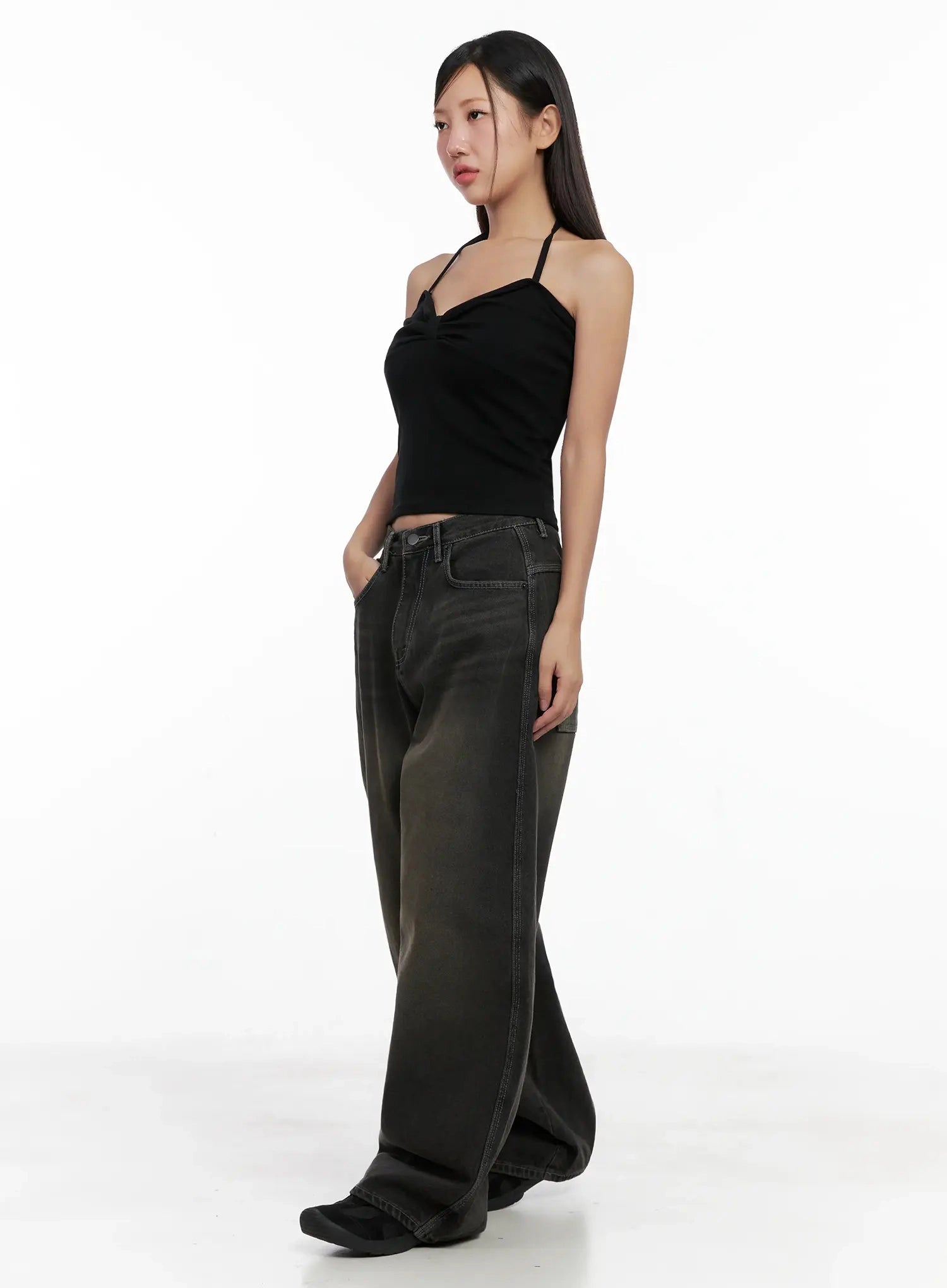 Hari Dark Washed Baggy Jeans IG527 in dark grey, three-quarter side shot on model, dark wash with brown gradient fade, wide leg drape, styled with black halter crop top, looking to side.