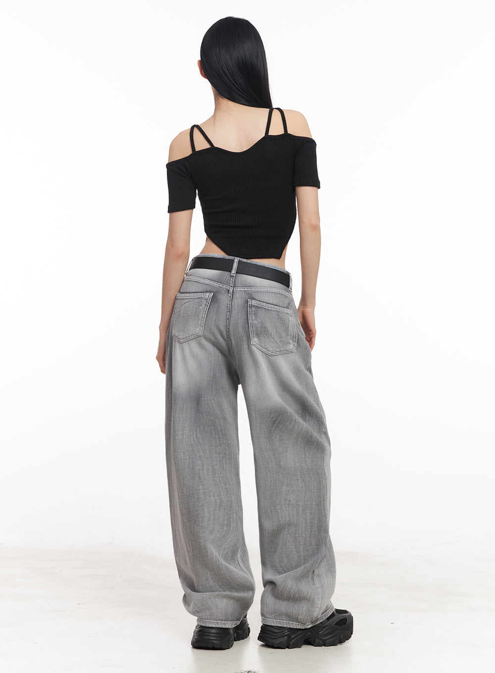 Flore Washed Wide-Leg Jeans IY516 in gray, back view on model, back patch pockets with washed fading across wide leg, black belt at waist, paired with black cold-shoulder crop top.