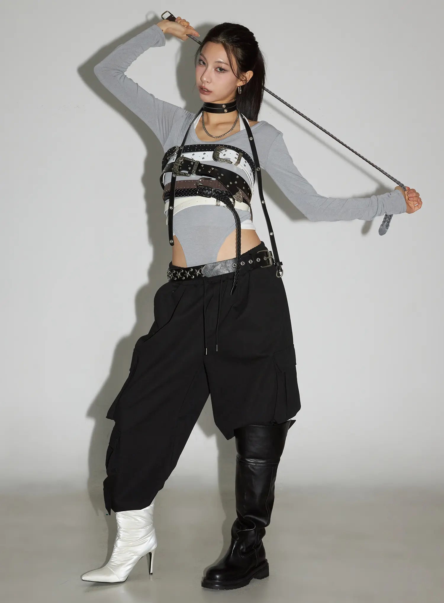 Wide Leg Cargo Pants CC1109 in black, editorial front shot on model, styled with belted harness, grey crop top, worn low with boots, dynamic street pose.