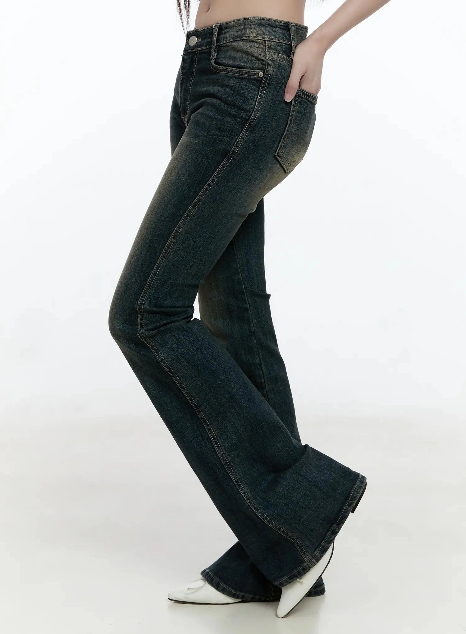 Karla Vintage Logo Hip Pad Flare Jeans IO520 in washed dark blue, side profile on model, full-length view showing slim thigh to wide flare hem, seam detail and vintage wash gradient visible.