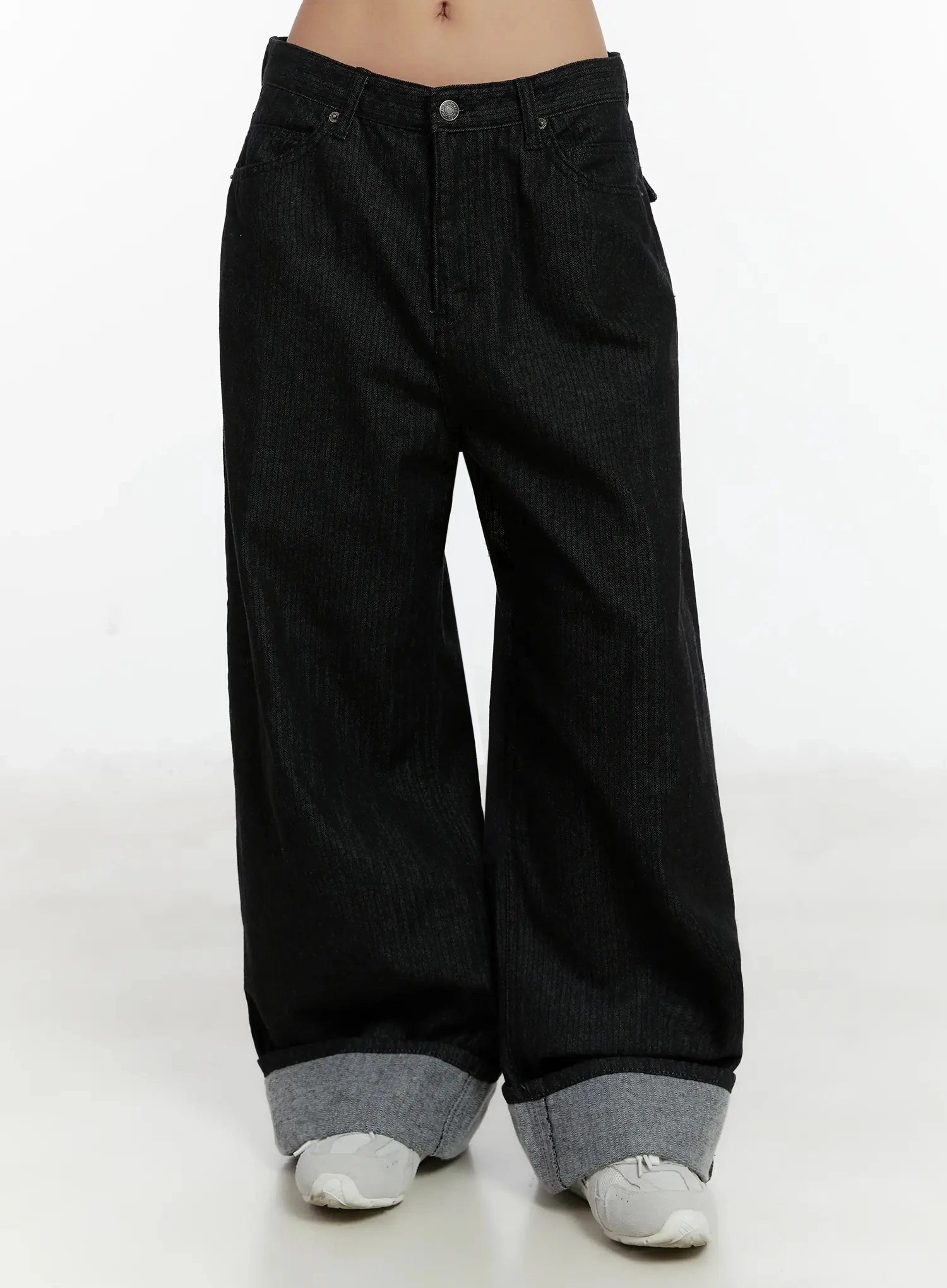 Amyra Baggy Striped Jeans ID525 in black, front view on model without top styling, low-rise waist with button closure, wide cotton denim leg and thick grey contrast cuff at hem.