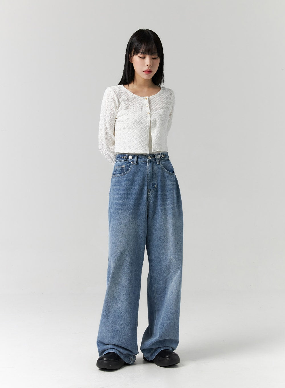 Side Stripes Wide Leg Jeans CS314 in blue, full-length front view on model looking down, high-rise washed wide-leg denim, floor-length hem, styled with white textured cropped cardigan.