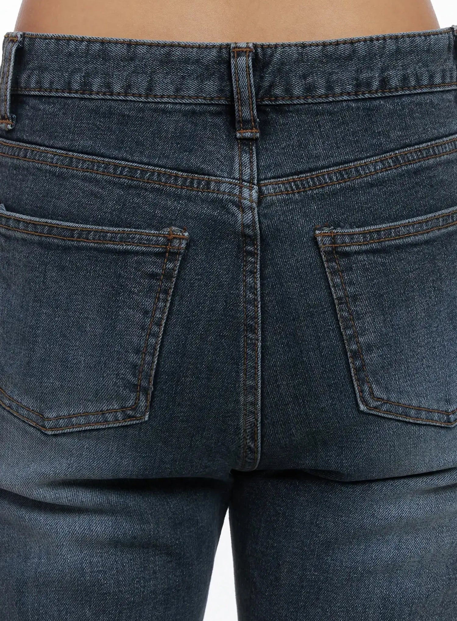 Rara Fleece Flared Jeans ID503 in blue, macro close-up of rear patch pockets, showing contrast orange topstitching, washed indigo denim texture, and belt loop on back waistband.
