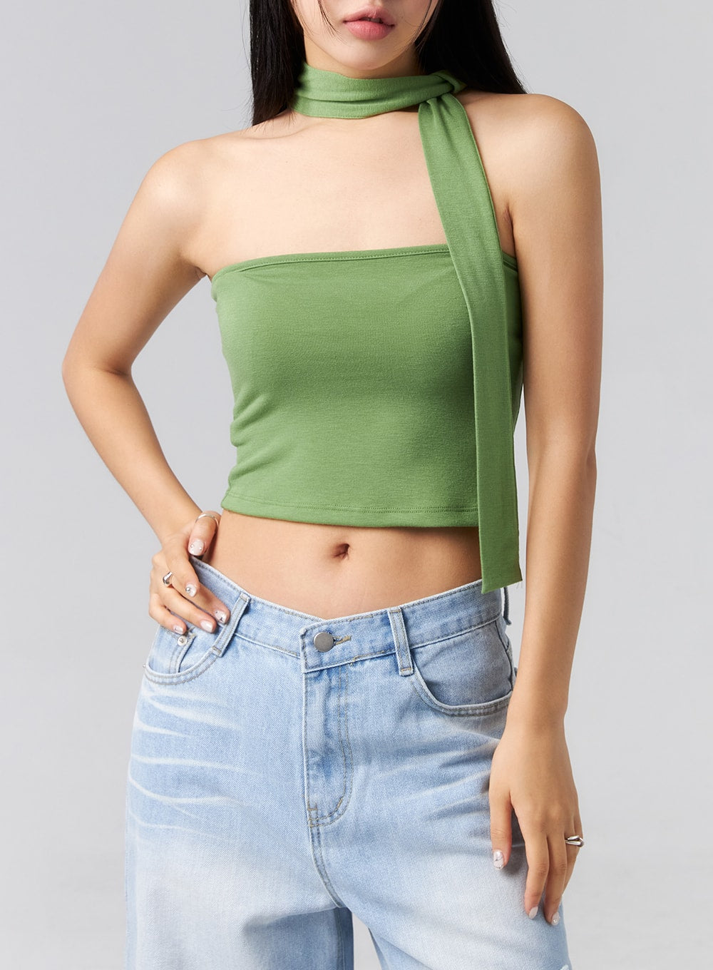 Ripped Side Jeans CL320 in light blue, upper-body close-up on model showing waistband and front pocket detail, wide-leg cotton denim with clean waistband and button fly, paired with green halter crop.