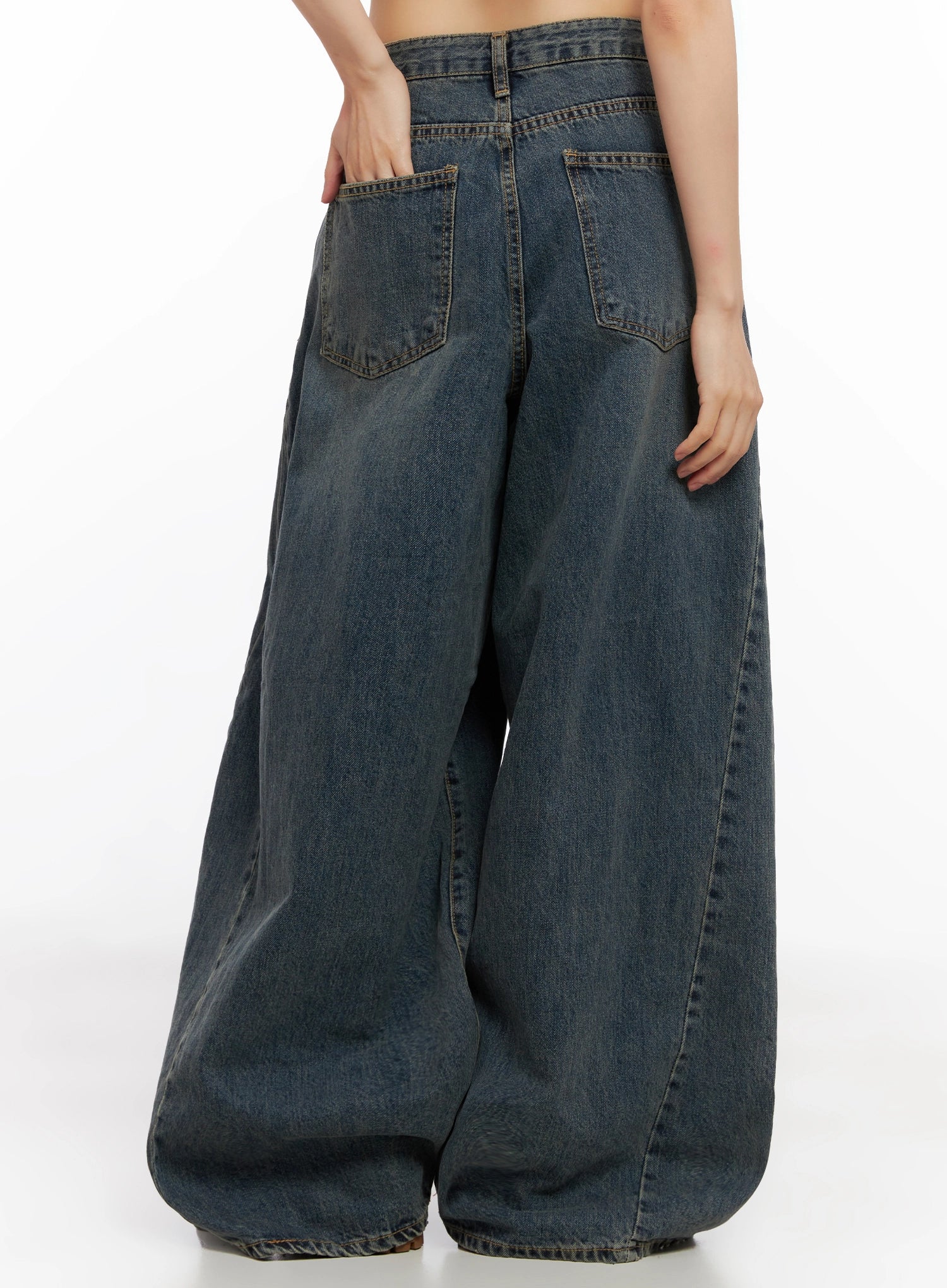 Skyler Washed Balloon Fit Jeans IN503 in blue, back three-quarter close-up on model, back patch pockets and washed fading detail, ballooned wide leg pooling at floor.
