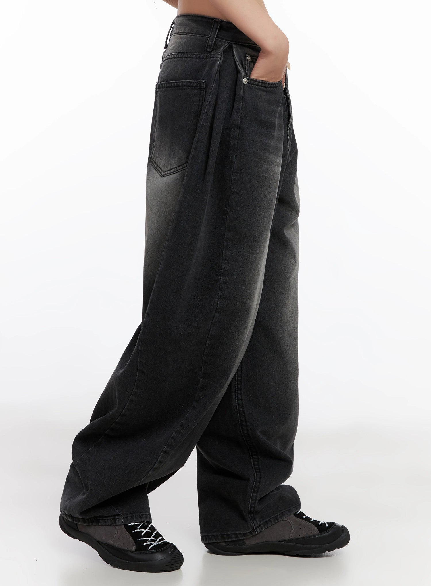 Ayra Dark Washed Baggy Jeans IS508 in dark grey, side view from waist to floor on model, emphasizing deep baggy drape, back pocket stitching, faded wash, and extra-long hem pooling over sneakers.