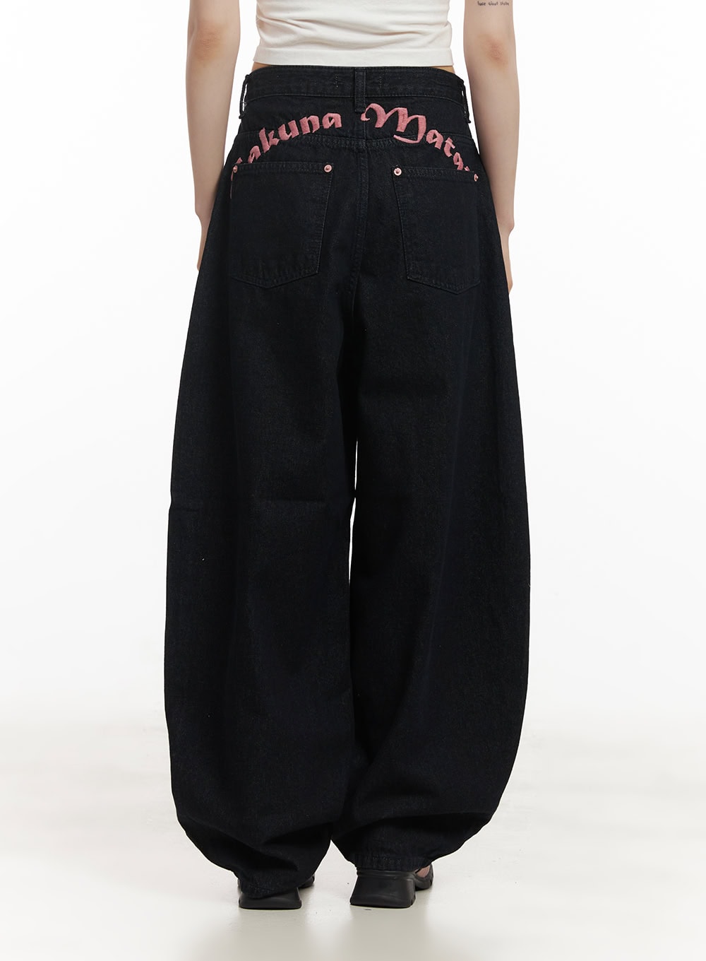 Dory Embroidered Baggy Jeans CF518 in dark blue, back full-body view on model showing pink Hakuna Matata lettering embroidery along waistband, balloon wide-leg hem pooling at floor.
