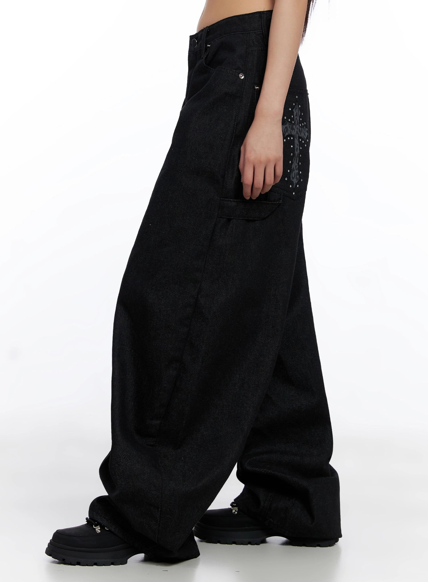 Lea Cross-Patch Baggy Jeans IS525 in black, side product shot on model, full-length view highlighting leopard cross patchwork and stud detailing on rear pocket, ultra-wide leg cotton denim silhouette.