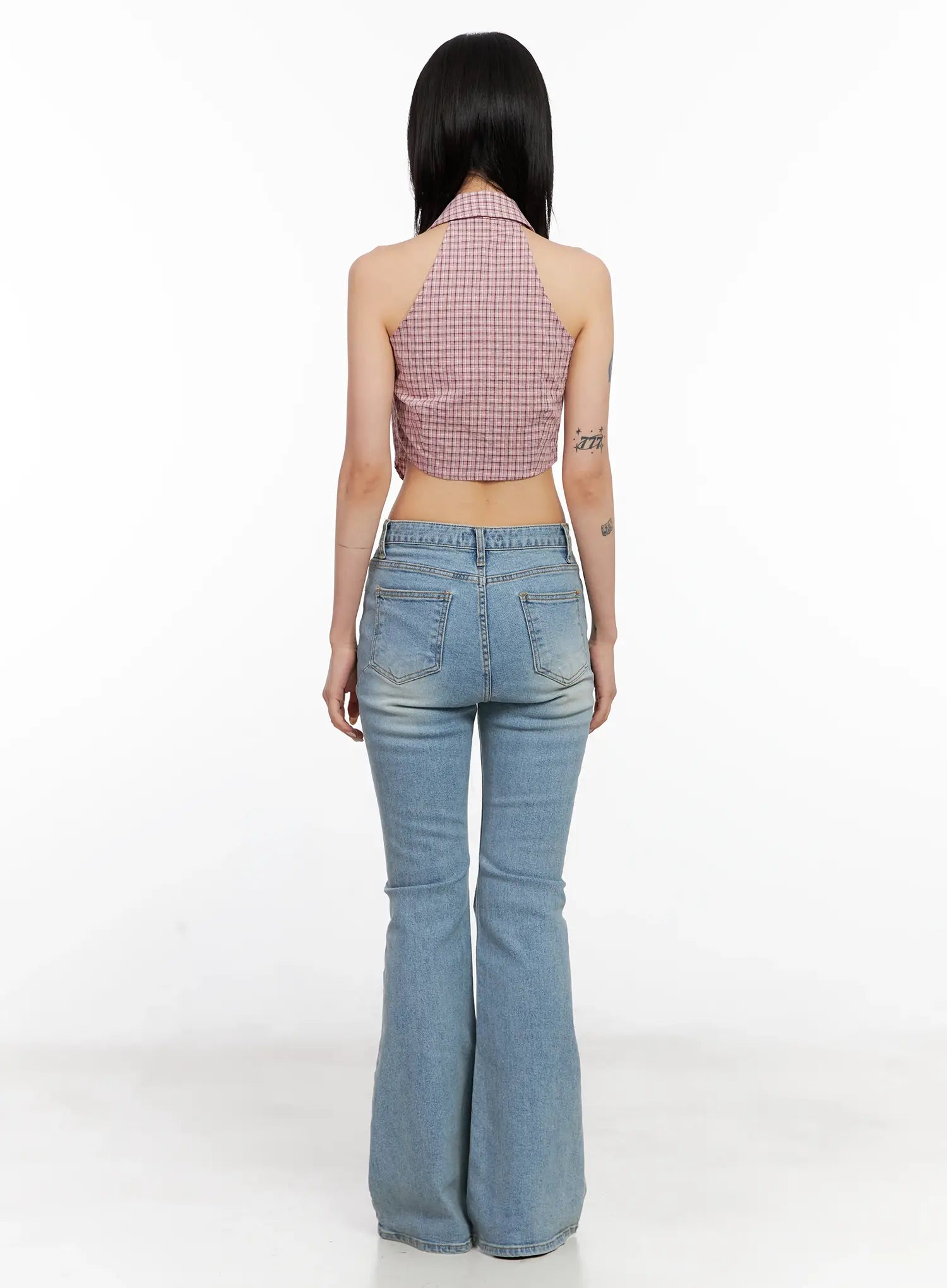 Byeol Washed Flare Denim Jeans CL525 in light blue, full back view on model styled with pink plaid crop halter, showing two back pockets and dramatic flare hem.