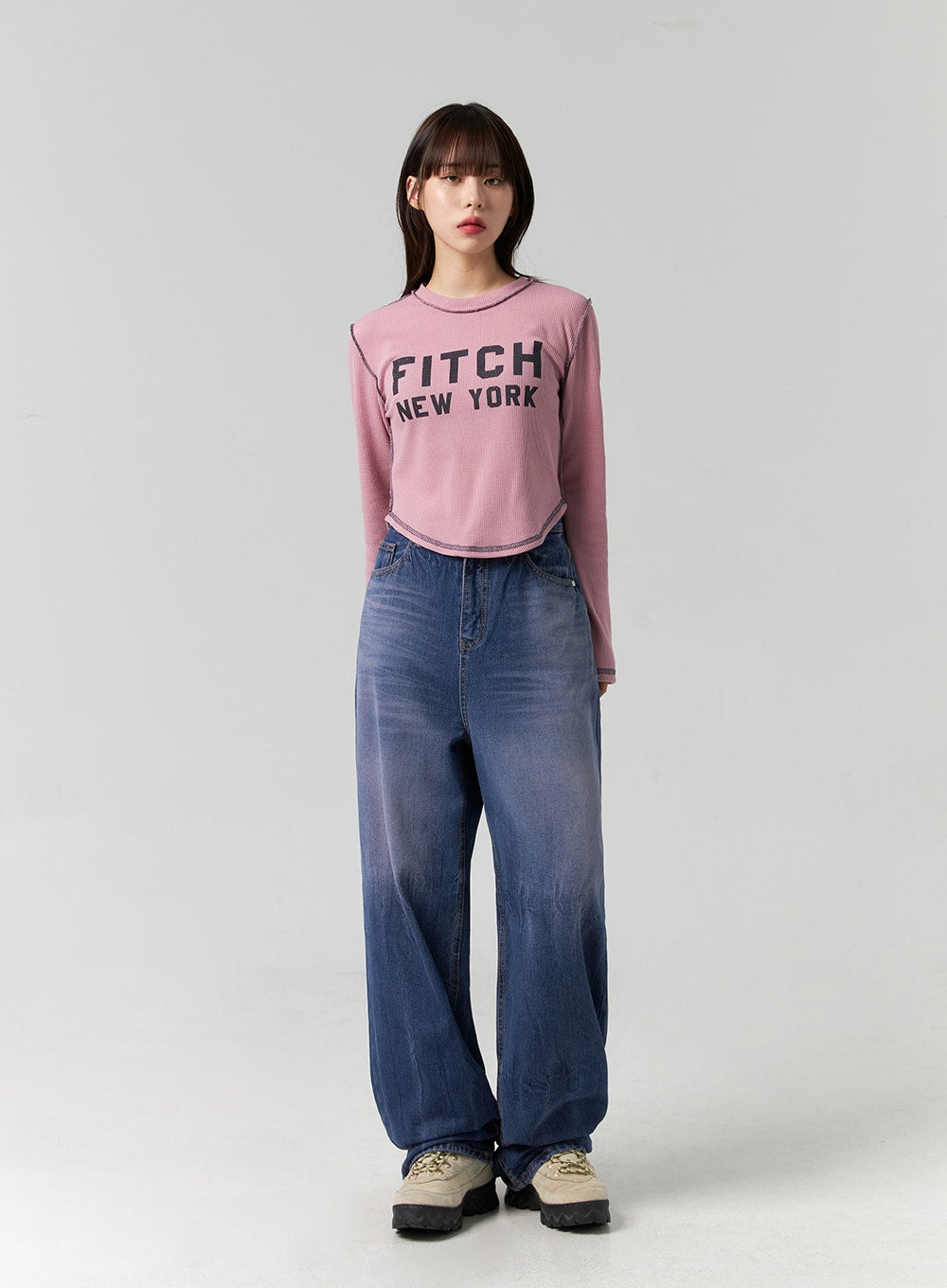 Wide Leg Cotton Jeans CG331 in blue, full front view on model in neutral stance, washed cotton denim wide leg with high waist, styled with pink graphic crop tee and sneakers.