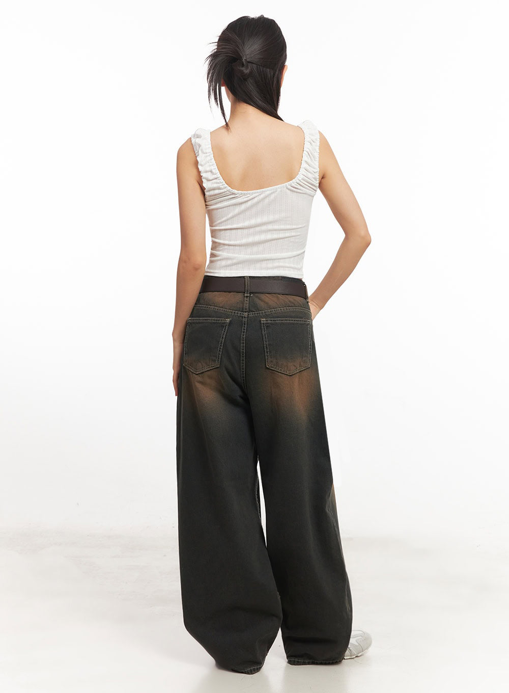 Bethany Vintage Washed Baggy Jeans IA524 in dark brown washed denim, back full-length view on model, showing back patch pockets, brown fade wash across seat and thighs, wide baggy leg, with white crop top.