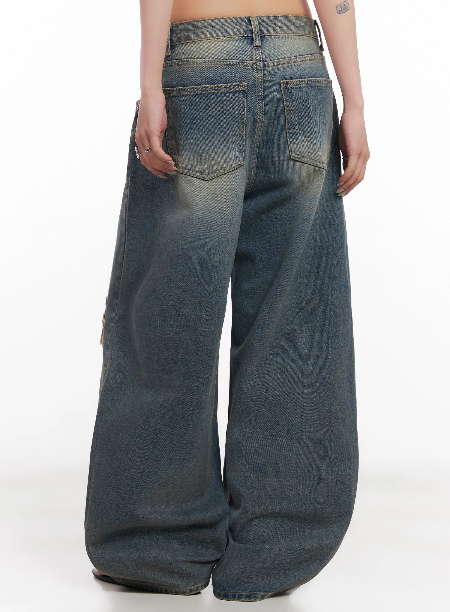 Jeemin Vintage Distressed Wide-Leg Denim Jeans IC503 in washed blue, back view on model, showing two rear pockets, golden-tinted washed denim, and extra-wide leg hem pooling on floor.