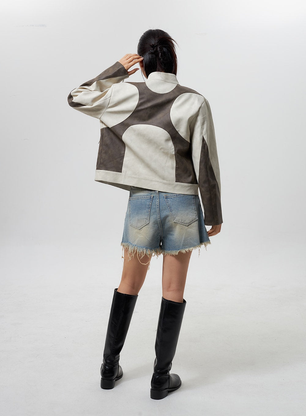Mid-Rise Ripped Jeans CY323 in light blue, back full-body on model, back pockets and raw frayed hem with vintage wash shown, layered with patchwork jacket and black knee boots.