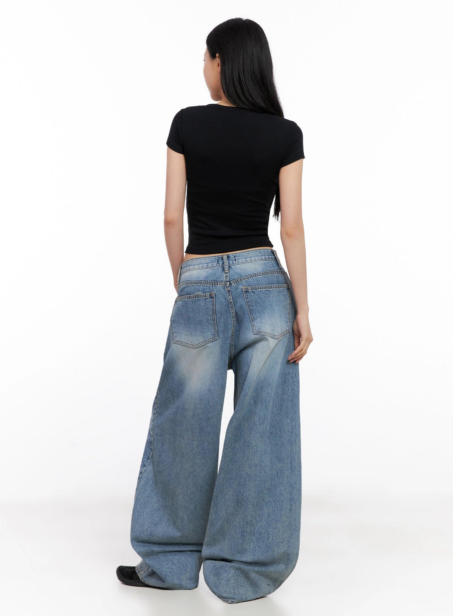 Seojin Washed Wide-Leg Jeans IG508 in blue, back full-length on model in black crop tee, back pockets and washed fade visible, voluminous wide leg pooling at floor.