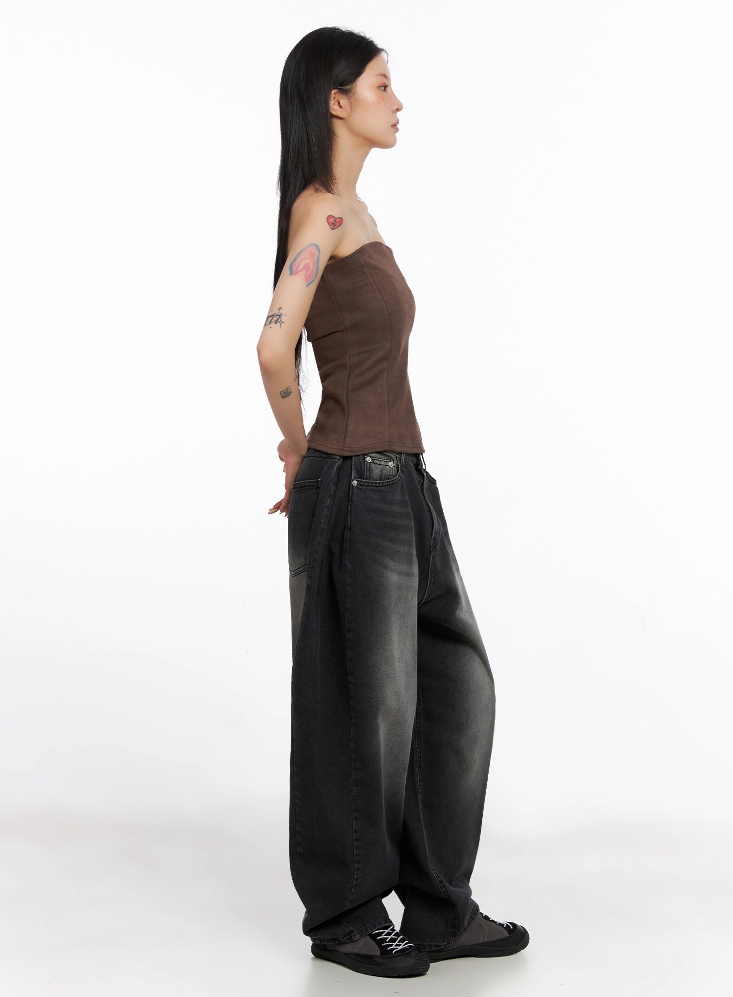 Ayra Dark Washed Baggy Jeans IS508 in dark grey, full-length side profile on model, wide-fit washed cotton denim with voluminous balloon-like leg, paired with brown strapless corset top and black sneakers.