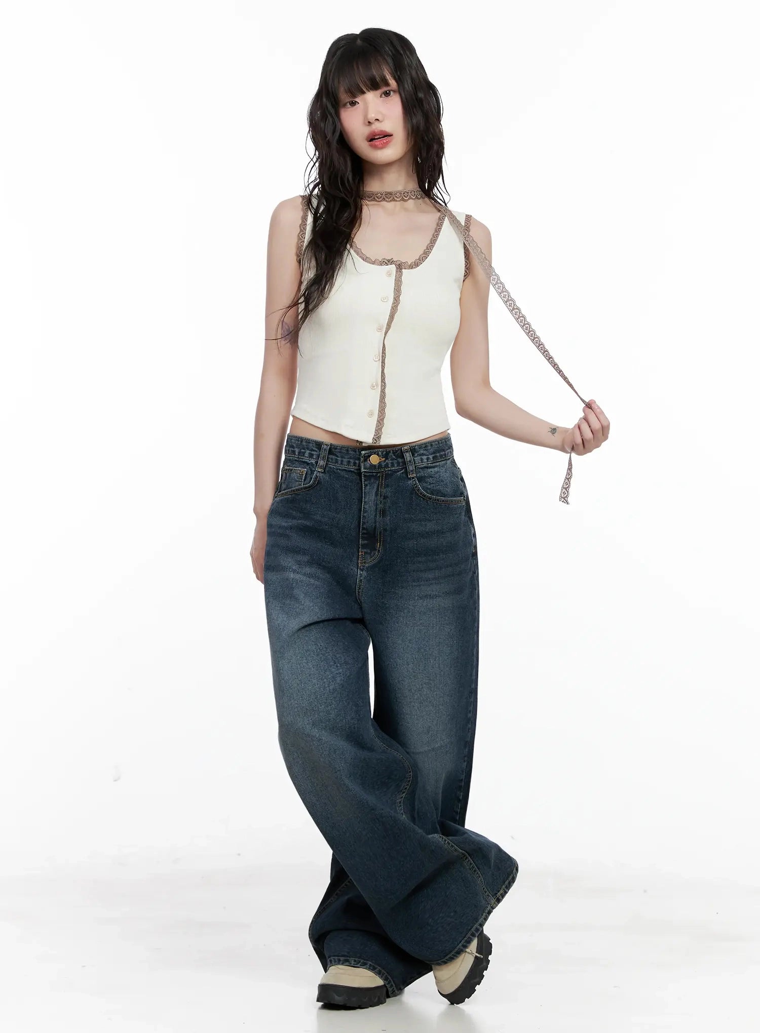 Mashiro Vintage-Wash Wide Jeans IL531 in dark blue, full-length front view on model holding lace strap accessory, wide-leg washed denim with five-pocket design, styled with white lace cami and chunky sneakers.