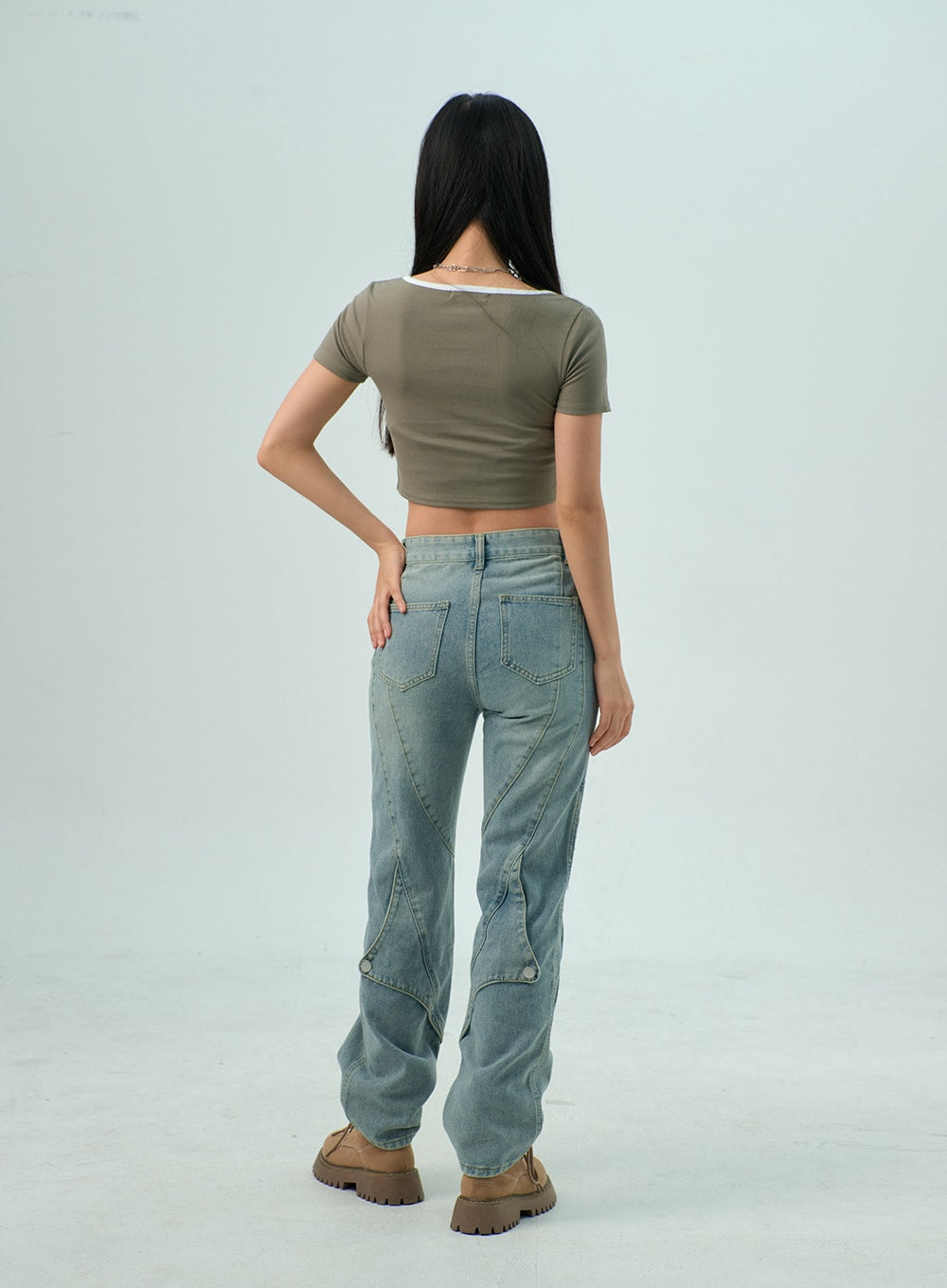 Straight Leg Jeans CY330 in light blue wash, full-length back shot on model, dual patch pockets, geometric panel stitching running down both legs, snap buttons at hem, straight cotton denim.