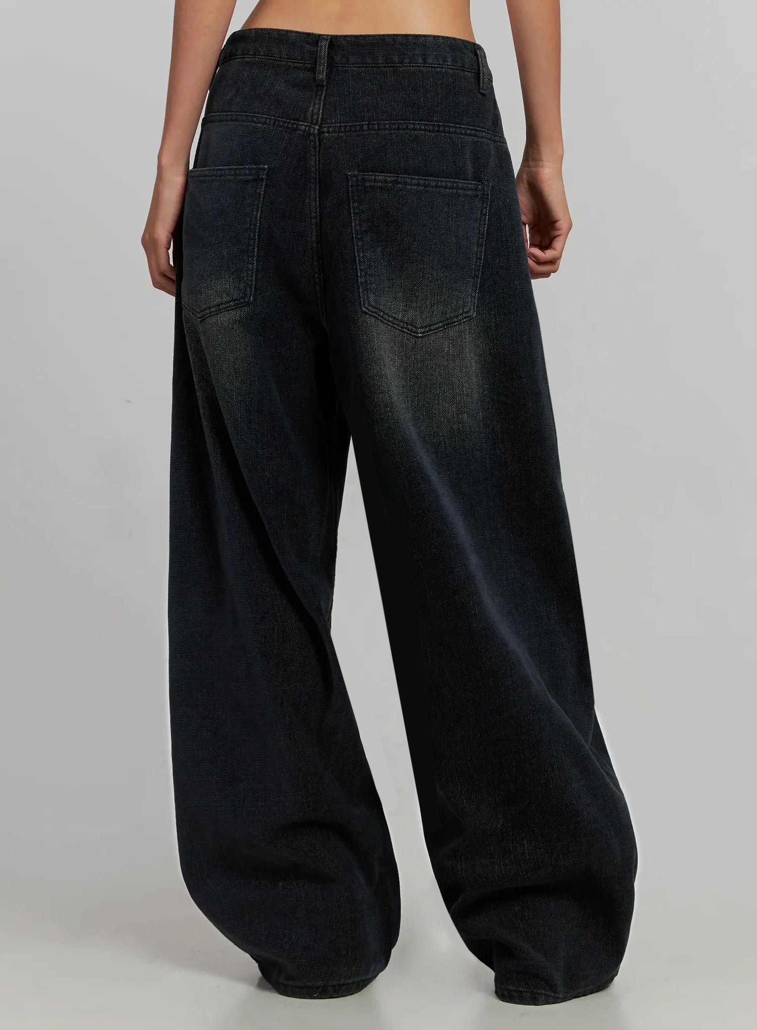 Aubree Washed Wide Jeans IJ502 in dark blue, back three-quarter close-up on model, showing oversized back patch pockets, contrast stitching, and faded wash on wide-leg hem.