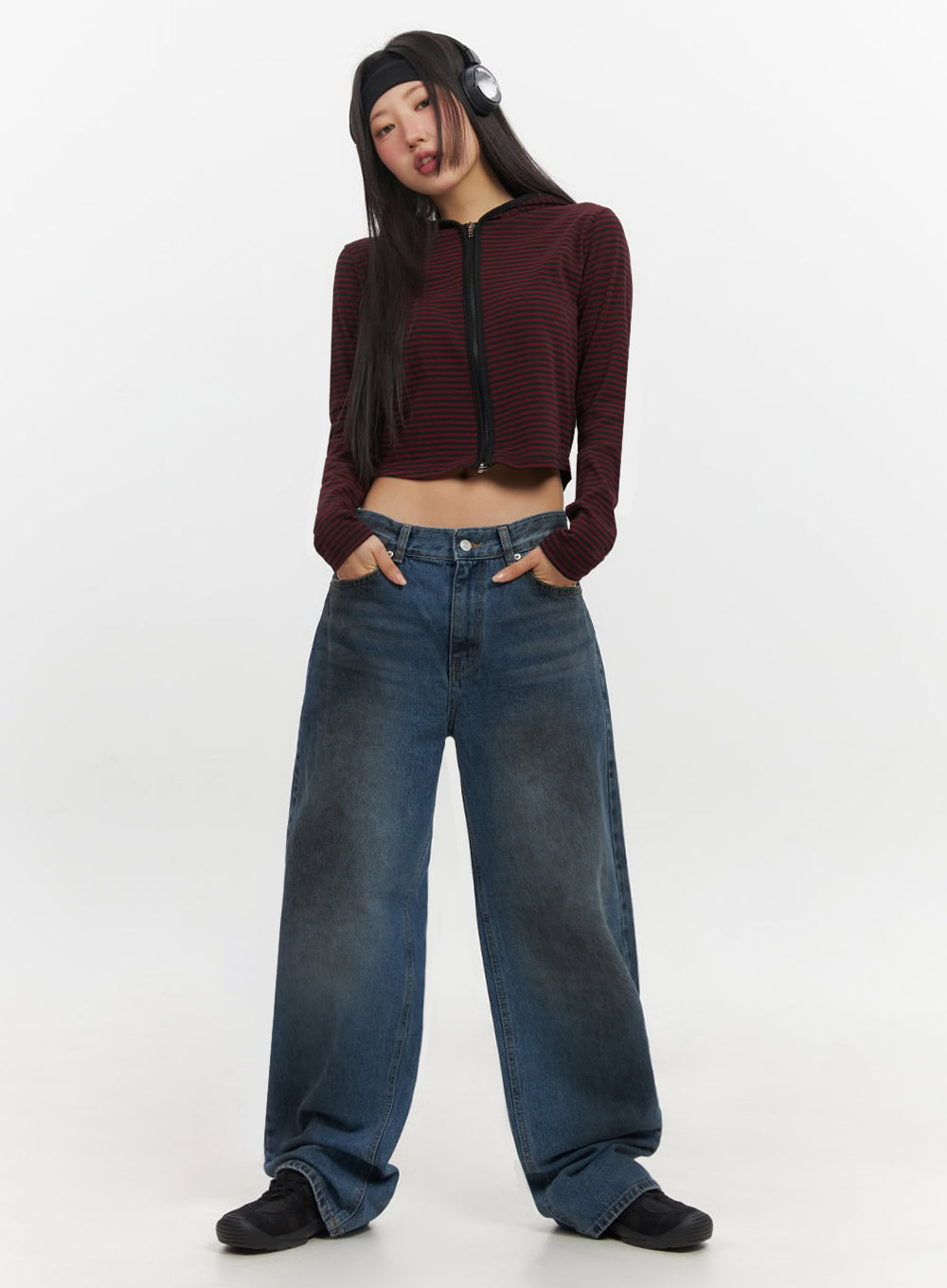 Brianna Dark Washed Wide-Leg Jeans IF510 in dark washed blue, full-body front on model with playful expression and headphones, low-rise wide-fit baggy denim, street acubi styling with crop hoodie.