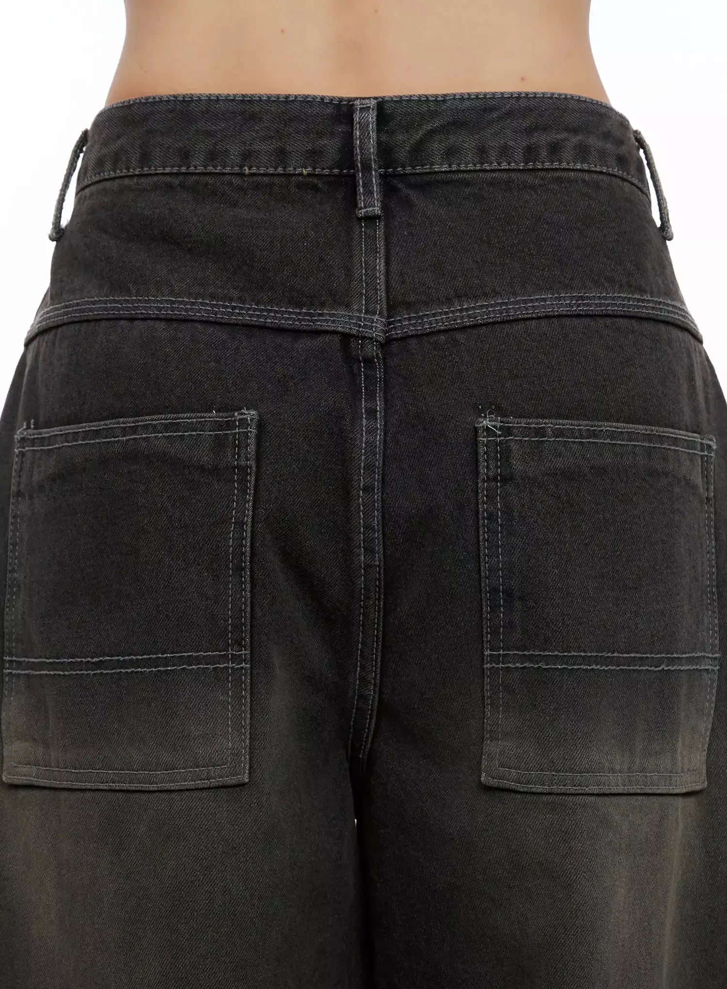 Hari Dark Washed Baggy Jeans IG527 in dark grey, close-up back detail shot on model, two large square patch pockets with contrast stitching, waistband drawstring detail and washed denim texture.