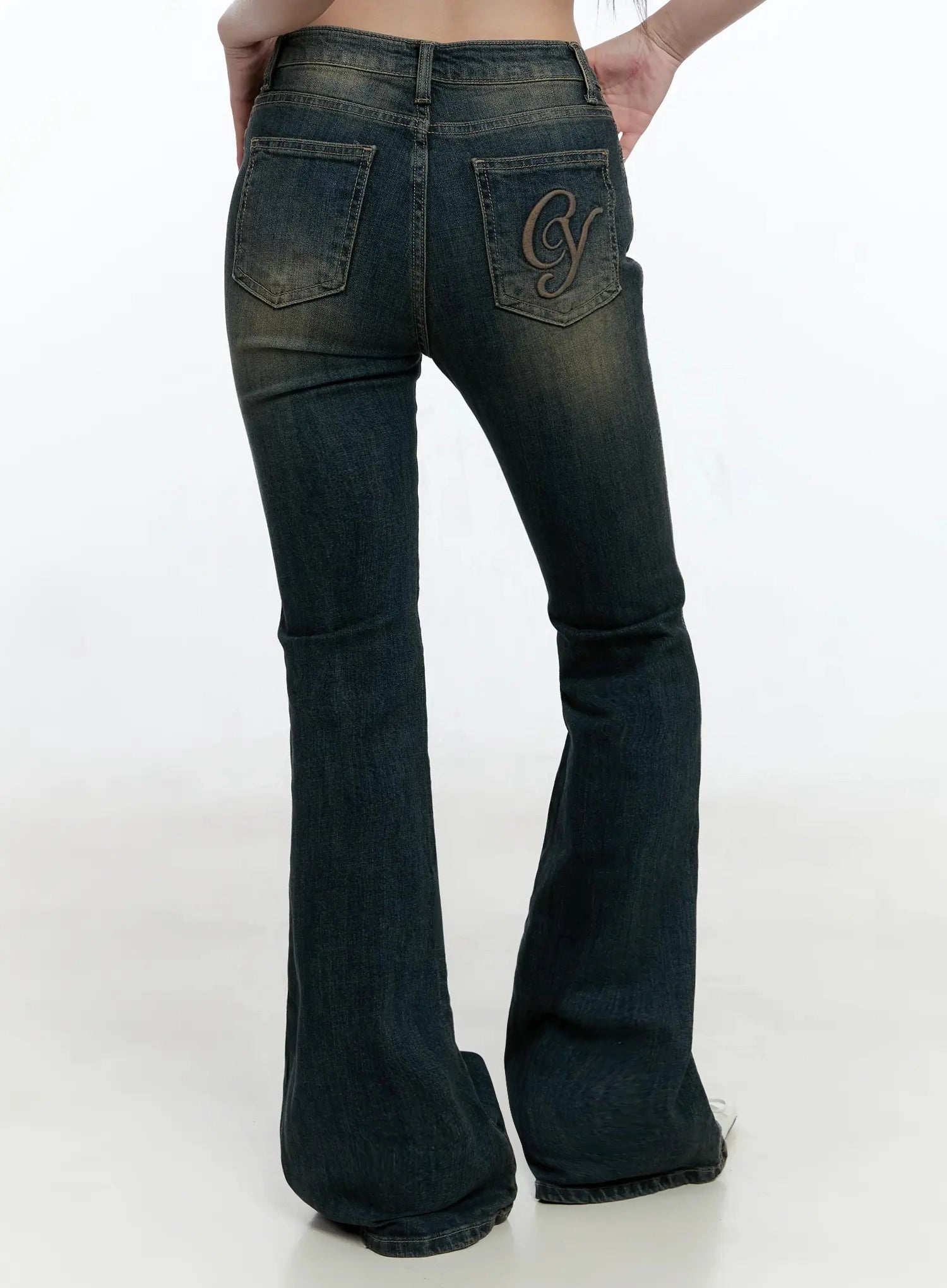 Karla Vintage Logo Hip Pad Flare Jeans IO520 in washed dark blue, back lower-half on model, both rear pockets visible with CY logo embroidery on right pocket, full flare hem length.
