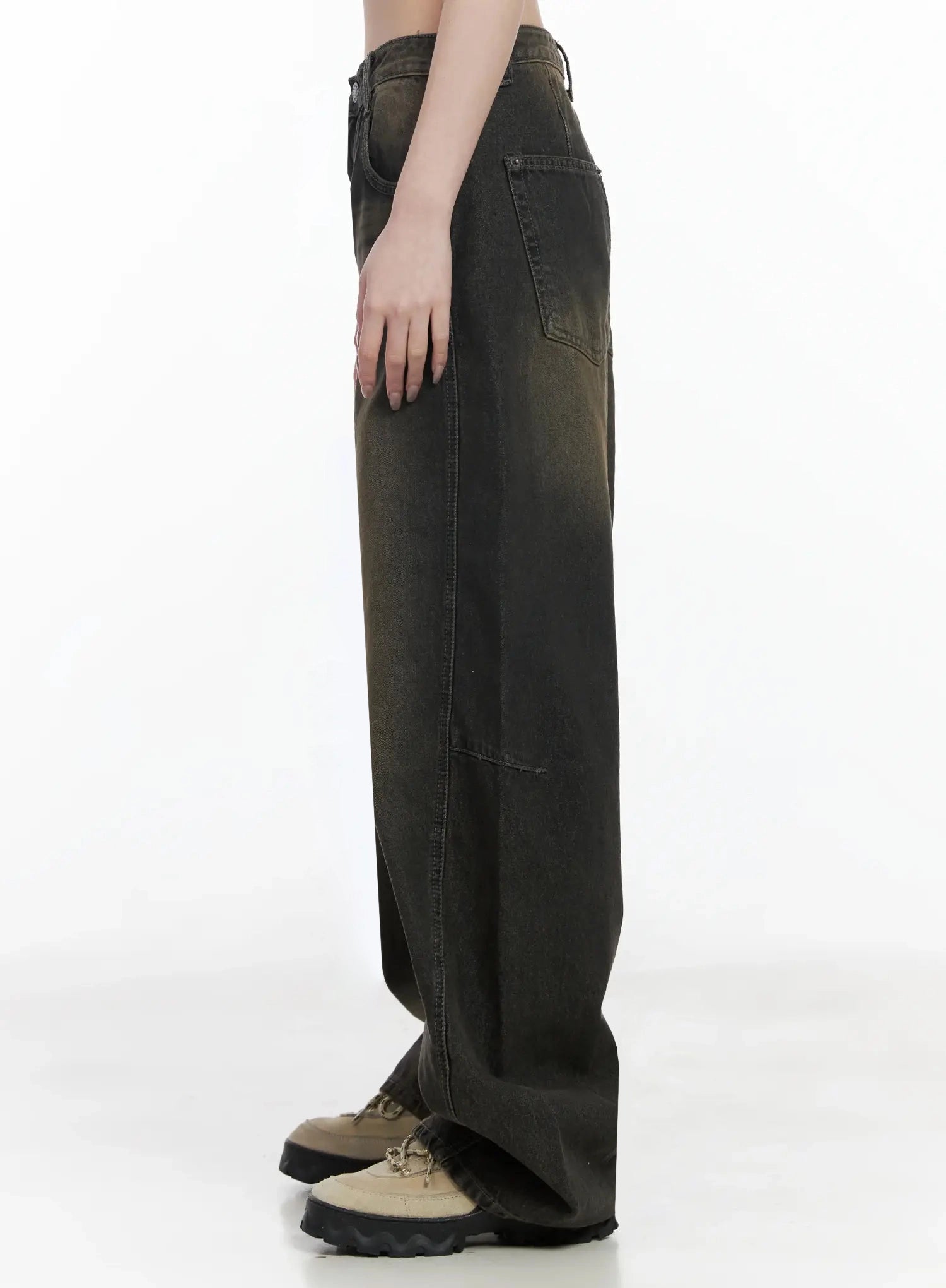 Tracey Vintage Black Washed Wide Leg Jeans IJ528 in black, side product shot headless on model, full-length view showing seam panel, brown vintage wash fade, wide leg hem over chunky sneakers.