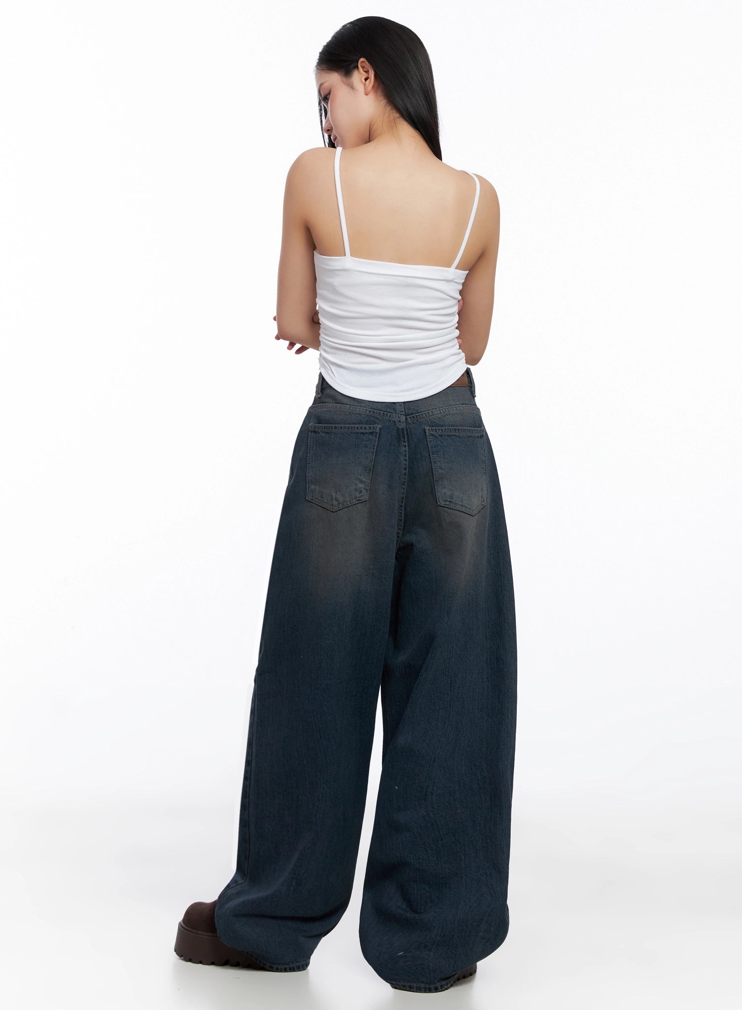 Adelyn Washed Baggy Jeans IS525 in dark blue, back full-body shot on model, showing two back pockets, washed denim fade, and pooling wide-leg hem, styled with white cami top.
