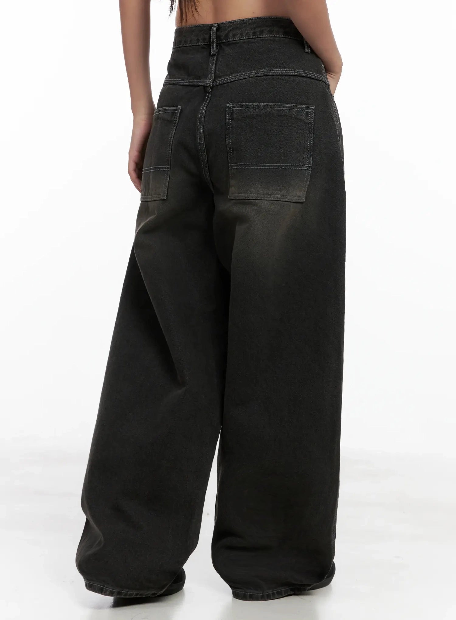 Hari Dark Washed Baggy Jeans IG527 in dark grey, back three-quarter view on model, oversized patch pockets, wide sweeping leg silhouette, contrast topstitching, dark washed cotton denim.