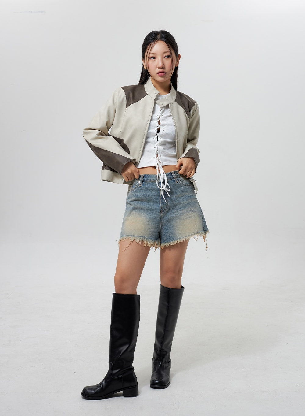 Mid-Rise Ripped Jeans CY323 in light blue, full-body front on model, ripped frayed-hem denim shorts with yellow fade, styled with open patchwork jacket, white lace-up crop tee and knee boots.