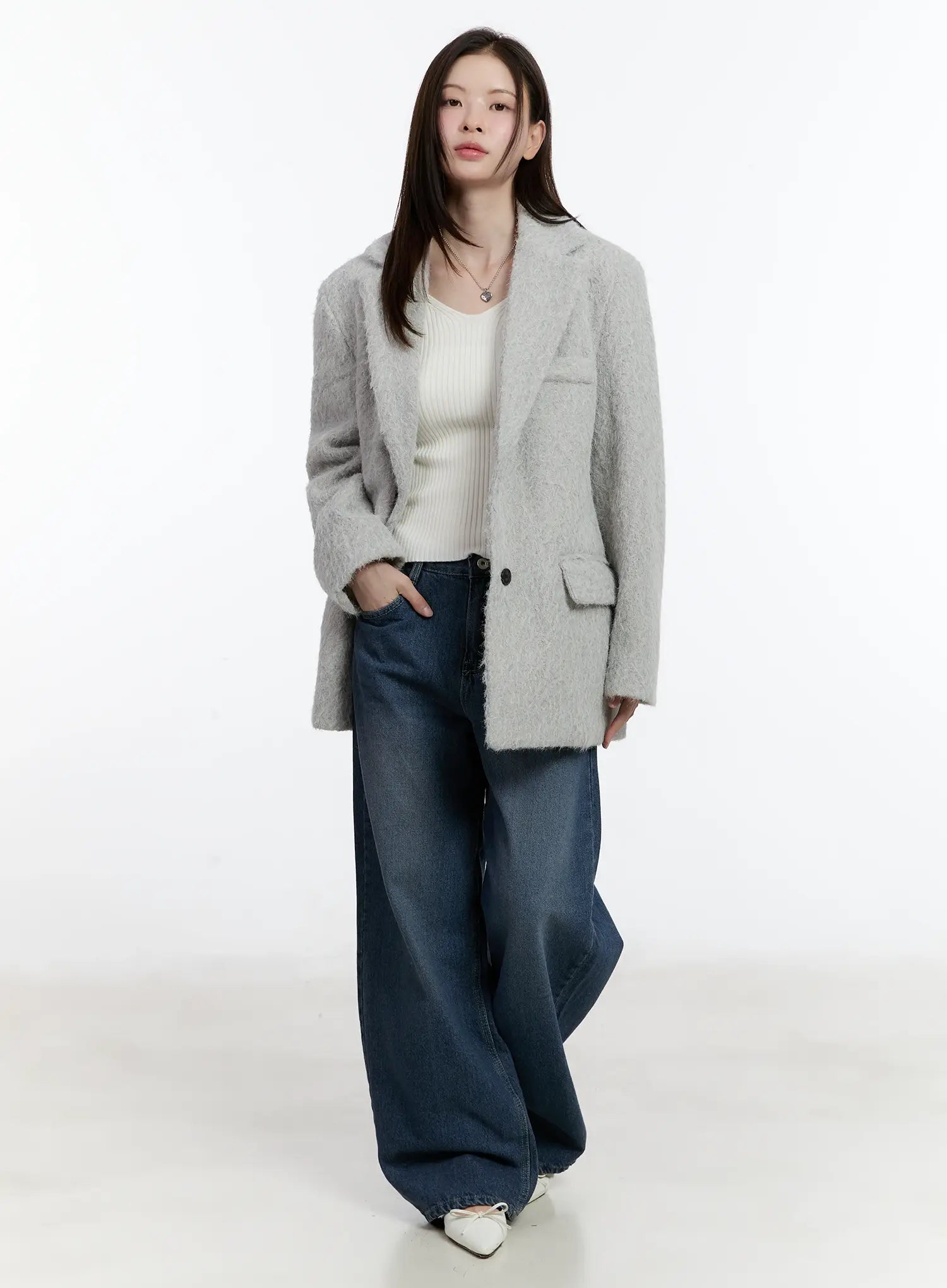 Della Casual Denim Wide Jeans ID511 in blue, full-body slight-angle shot on model, washed wide-fit cotton denim, long length, styled with grey fuzzy blazer, cream ribbed knit, and white flats.