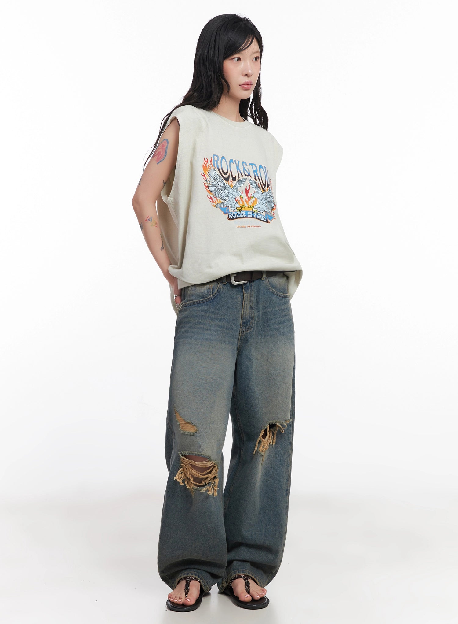 Jeemin Vintage Distressed Wide-Leg Denim Jeans IC503 in washed blue, full-length front view on model, styled with oversized rock-print graphic tee and belt, destroyed thigh rips prominent.