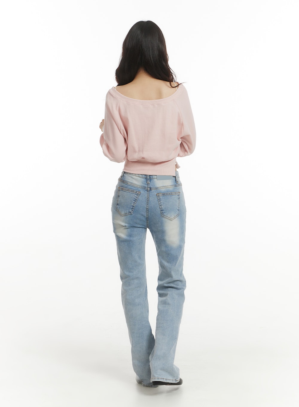 Light Washed Bootcut Jeans OF427 in light blue, back full-body view on model, two back pockets with stitching, washed fading detail, slim fit through hip and bootcut hem.