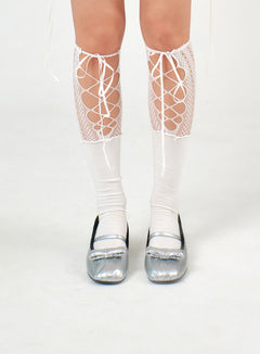 LEWKIN Bow Decor Mary Jane Flats IJ402 in light gray, front close-up on model's feet, metallic silver faux leather with padded toe, ribbon bow detail, worn with lace-up fishnet knee socks.