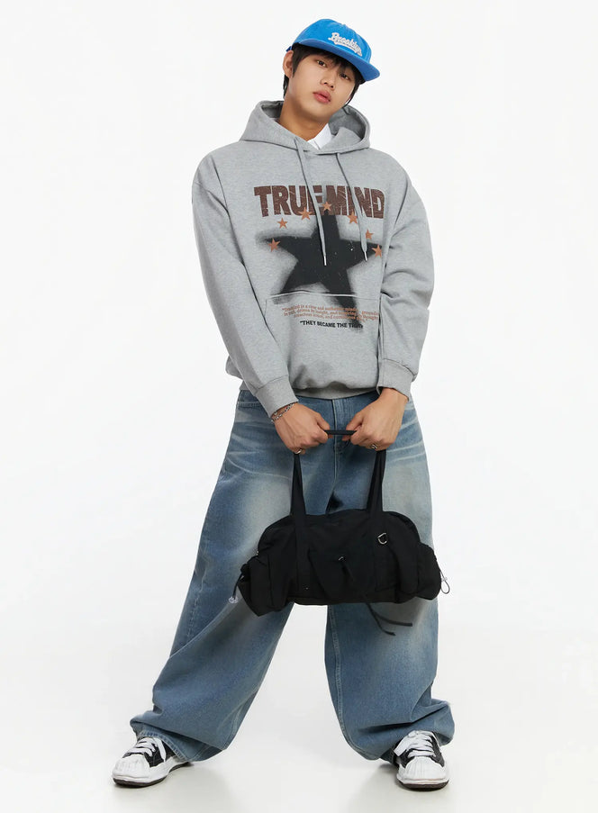LEWKIN Men's Graphic Hoodie IF503 in grey, full-body front on model wearing blue cap, oversized fleece with TRUEMIND star print, styled with wide-leg jeans and black bag.
