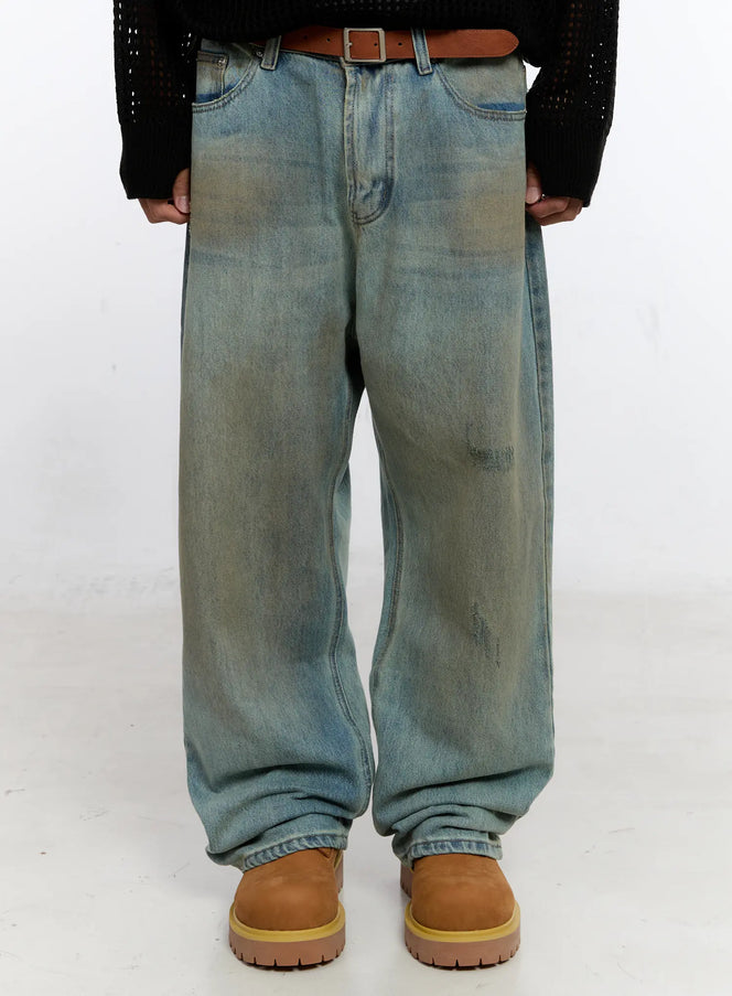 LEWKIN Men's Vintage Wash Wide Fit Jeans IS529 in light blue, front waist-to-hem shot on model, wide-leg silhouette with heavy vintage wash, distressed details, worn with brown leather belt and tan boots.
