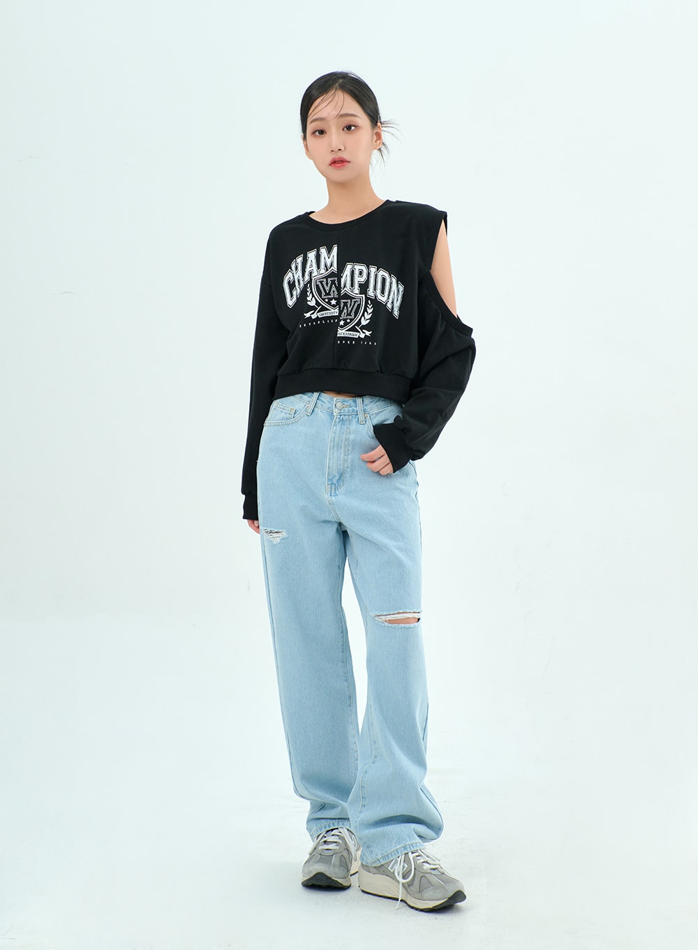 Ripped Basic Jeans BA328 in light blue, full-body slightly angled front shot on model, wide-leg destroyed denim with dual knee slits, paired with black cut-out graphic sweatshirt and sneakers.