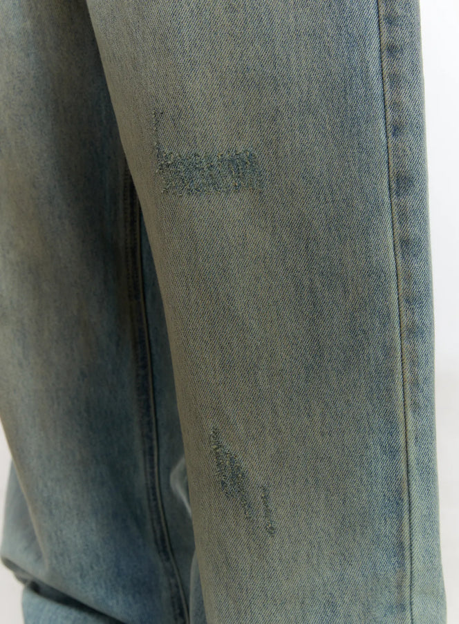 Men's Vintage Wash Wide Fit Jeans IS529 in light blue, close-up detail of thigh area showing distressed abrasion marks and whisker fading on denim fabric surface.