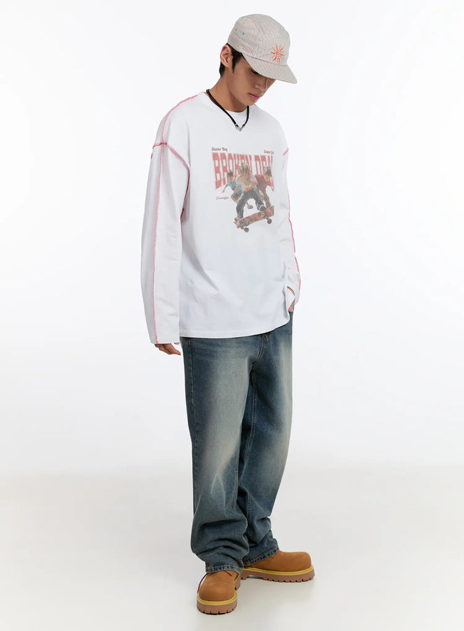 Bold Link Statement Chain Necklace IN528 in black, full-body styling shot on male model, layered over white long-sleeve graphic tee, wide-leg jeans, and tan boots, viewed from slight angle.
