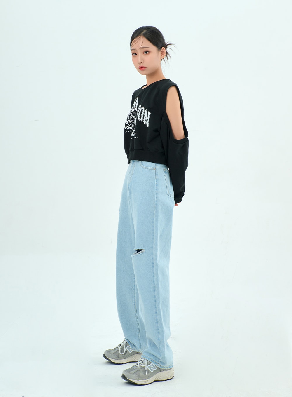 Ripped Basic Jeans BA328 in light blue, full-length side view on model, wide-leg high-rise denim with open knee rip, styled with black graphic sweatshirt and grey sneakers.